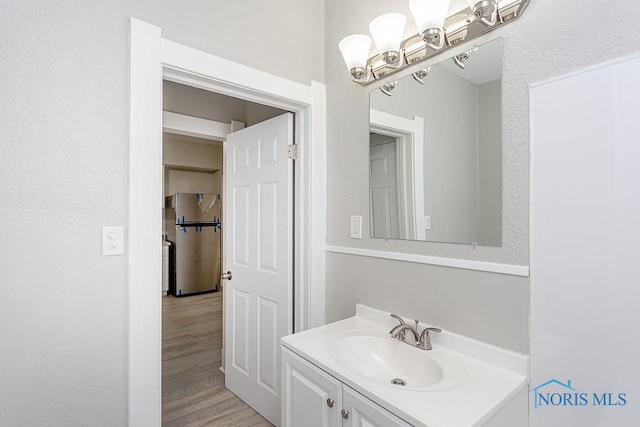 bathroom with vanity and hardwood / wood-style flooring