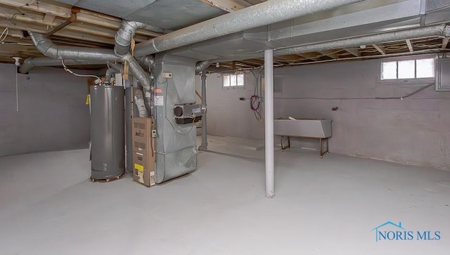 basement featuring heating unit and water heater