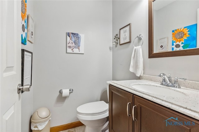 bathroom featuring toilet and vanity