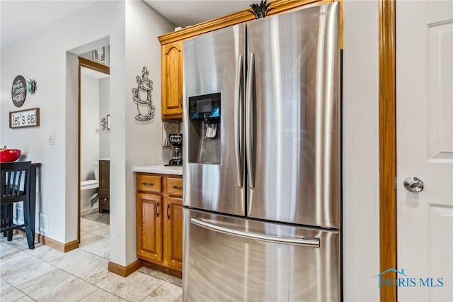 kitchen featuring stainless steel refrigerator with ice dispenser