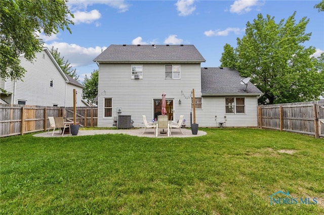 rear view of house featuring a patio area, a yard, and cooling unit