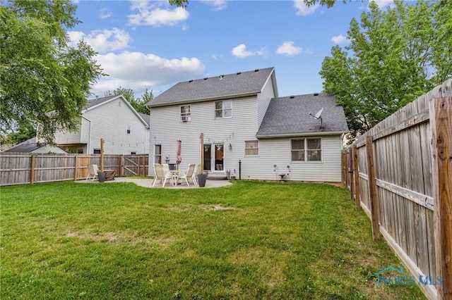 rear view of property featuring a yard and a patio