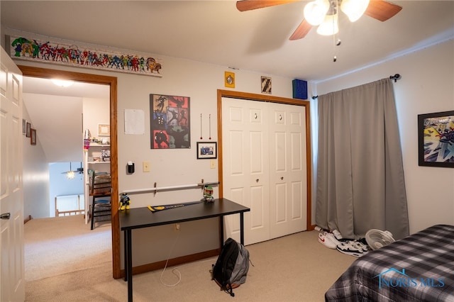 carpeted bedroom with ceiling fan and a closet