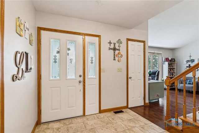 foyer entrance with light hardwood / wood-style floors