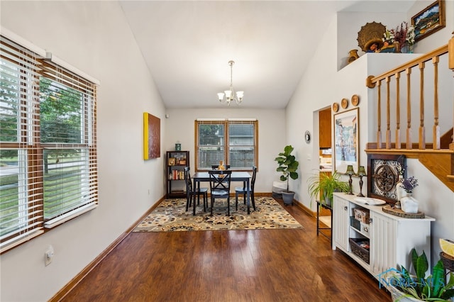 dining area featuring vaulted ceiling, dark hardwood / wood-style flooring, plenty of natural light, and a chandelier