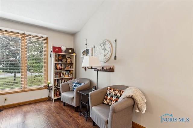 sitting room with dark wood-type flooring and lofted ceiling