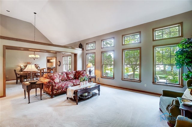 living room with high vaulted ceiling, light carpet, and a notable chandelier