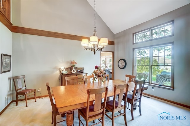 dining space featuring high vaulted ceiling, light carpet, and a notable chandelier