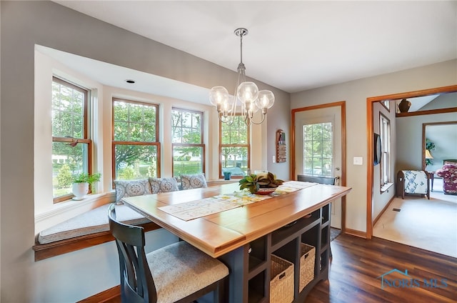 dining space with an inviting chandelier and hardwood / wood-style flooring