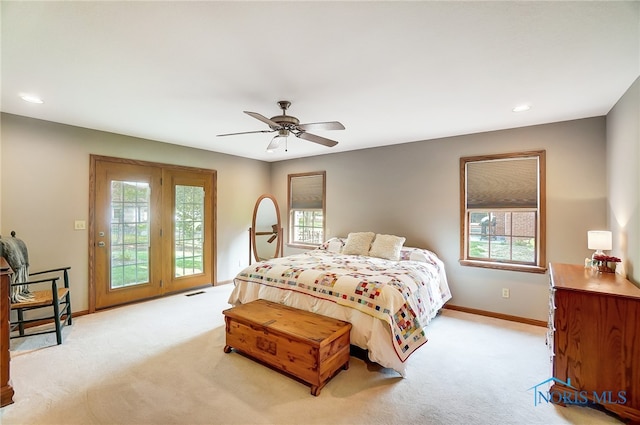 carpeted bedroom with multiple windows and ceiling fan