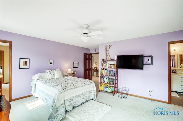 carpeted bedroom featuring ensuite bathroom and ceiling fan