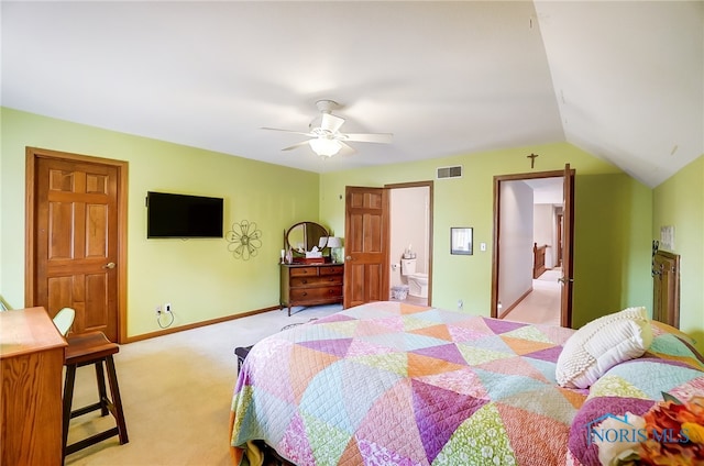 carpeted bedroom with connected bathroom, ceiling fan, and lofted ceiling