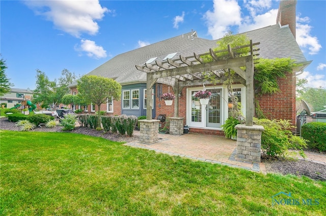 back of property with a patio area, a lawn, and a pergola