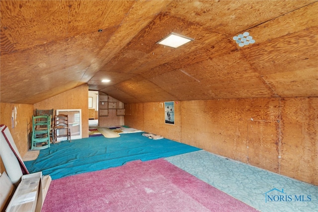 unfurnished bedroom featuring carpet and vaulted ceiling