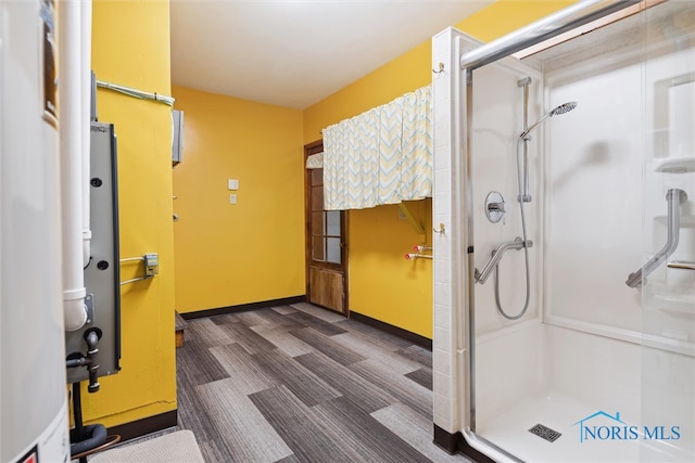 bathroom with a shower with door