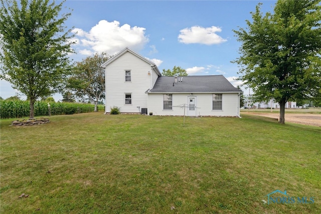 rear view of house with a yard