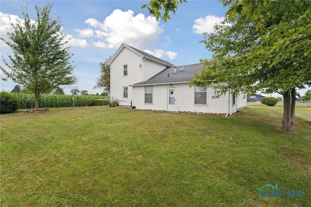 view of side of property featuring a yard