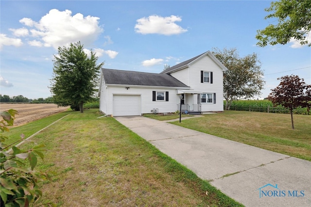 view of front of home featuring a garage and a front lawn