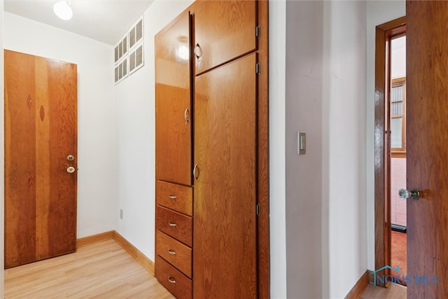 hall with light wood-type flooring