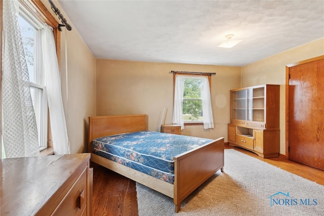 bedroom with light wood-type flooring