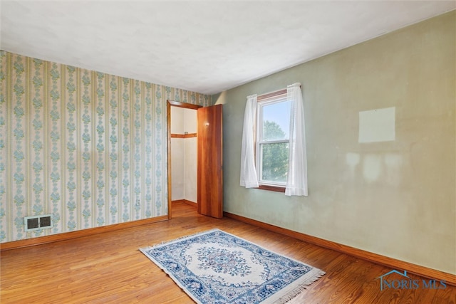 spare room featuring hardwood / wood-style floors