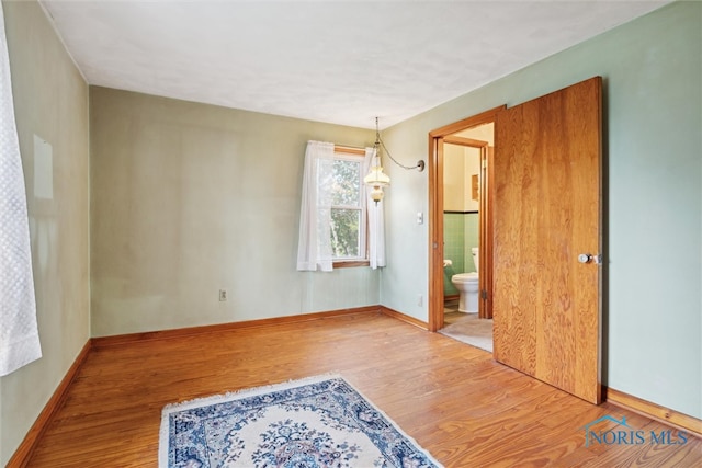 spare room with hardwood / wood-style flooring