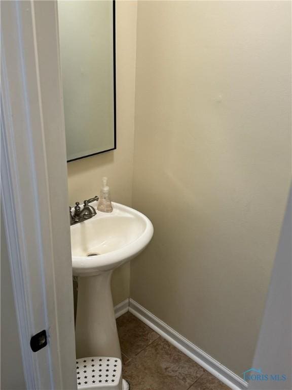 bathroom with tile patterned flooring and baseboards