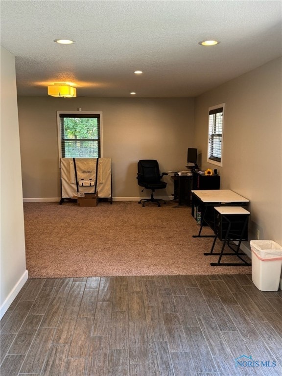 office space with dark wood-type flooring and a textured ceiling