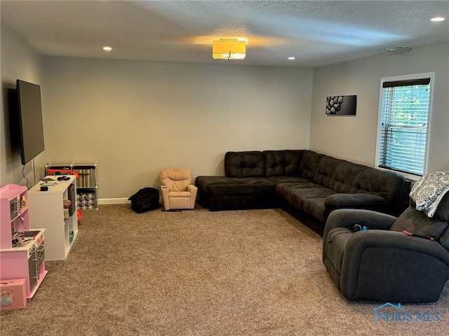 living area featuring recessed lighting, light carpet, a textured ceiling, and baseboards