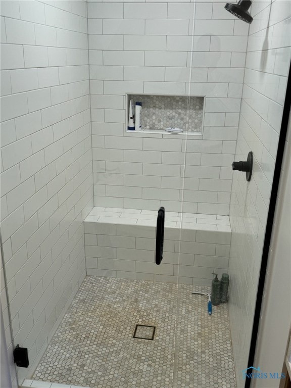 bathroom with a shower with door