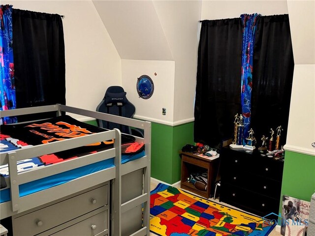 bedroom with lofted ceiling