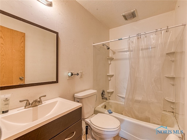 full bathroom with tile patterned flooring, shower / bathtub combination with curtain, toilet, vanity, and a textured ceiling