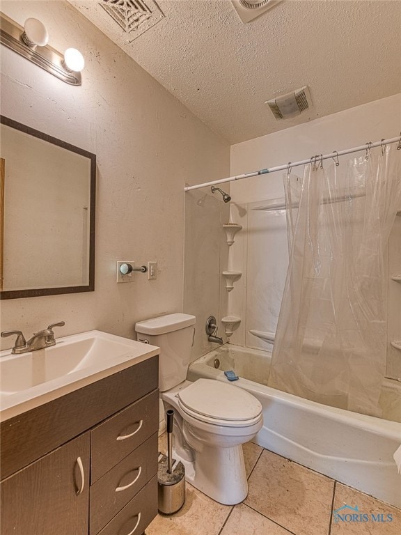 full bathroom featuring a textured ceiling, vanity, shower / bath combination with curtain, toilet, and tile patterned floors