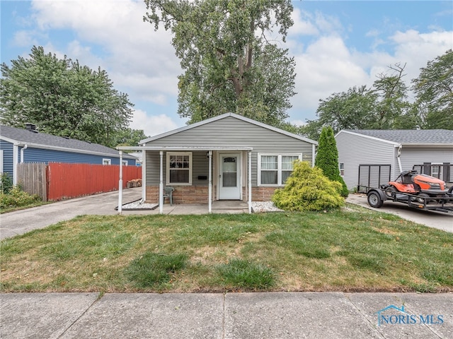 view of front of property with a porch, a garage, and a front lawn