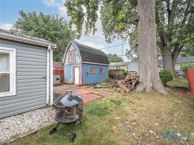 view of yard with a storage shed and an outdoor fire pit