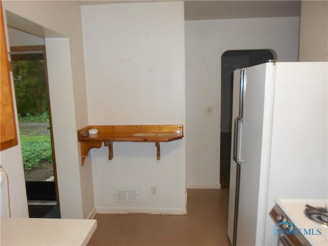 kitchen featuring range and white refrigerator