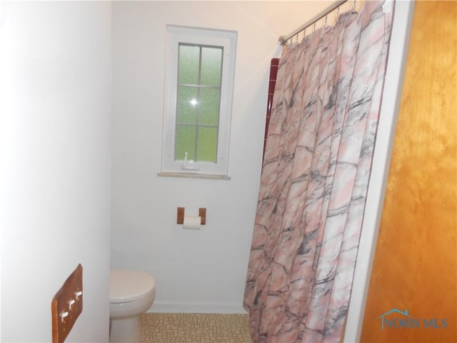 bathroom featuring tile patterned flooring and toilet