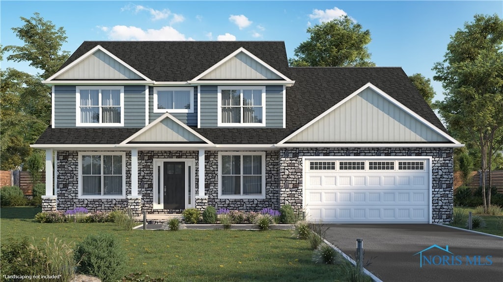 craftsman house featuring a front yard and a garage