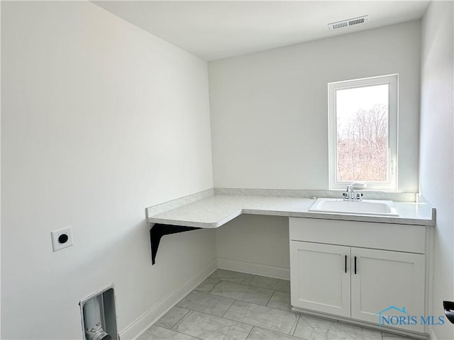 washroom with marble finish floor, cabinet space, visible vents, a sink, and electric dryer hookup