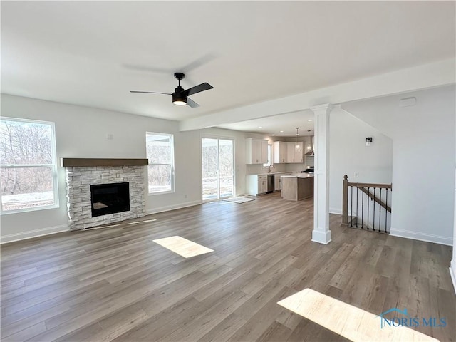 unfurnished living room featuring ceiling fan, recessed lighting, baseboards, and light wood-style floors