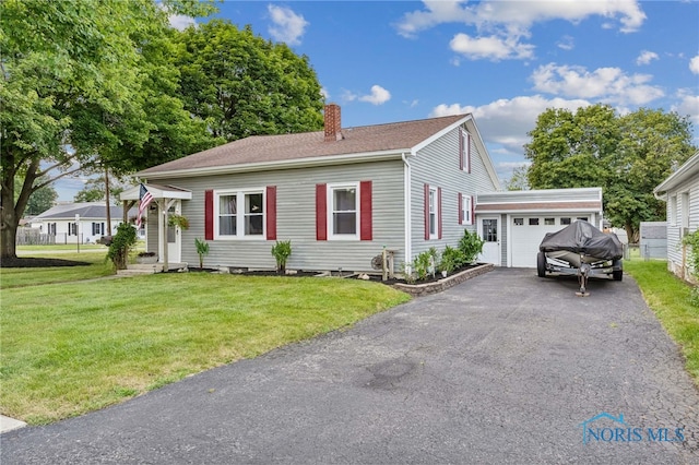 view of front of home featuring a garage and a front yard