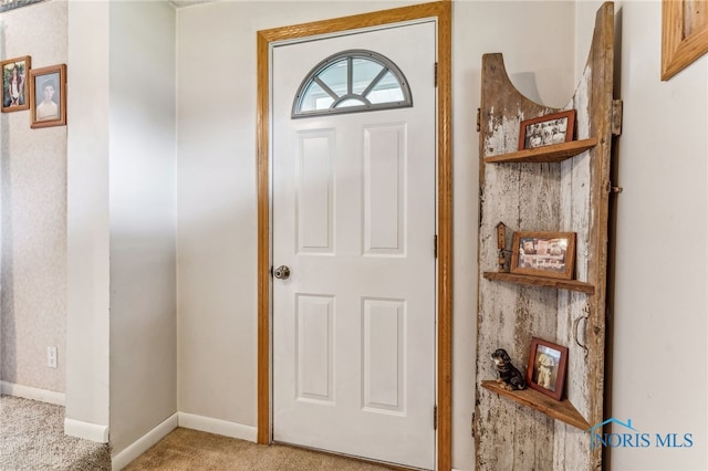 view of carpeted entrance foyer