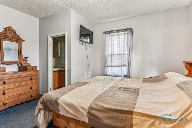 bedroom featuring carpet, a textured ceiling, and ensuite bathroom