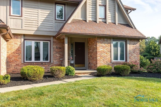 view of front of property with brick siding and a front yard