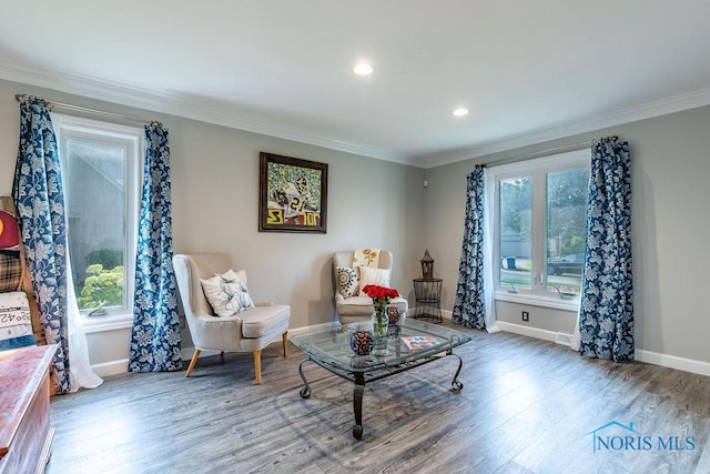 living area featuring ornamental molding, recessed lighting, baseboards, and wood finished floors