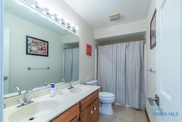 full bath with tile patterned flooring, a sink, toilet, and double vanity