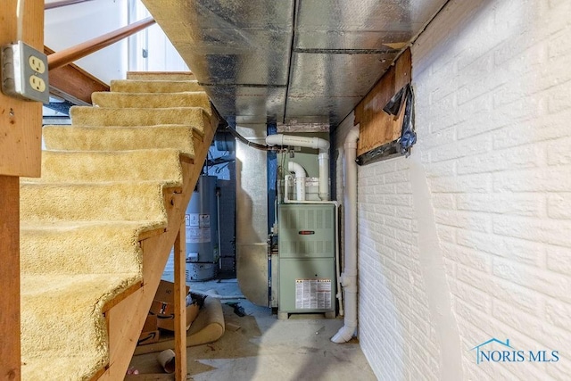 utility room featuring heating unit and water heater