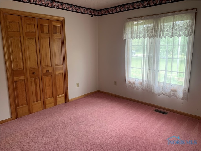 unfurnished bedroom with a closet and carpet