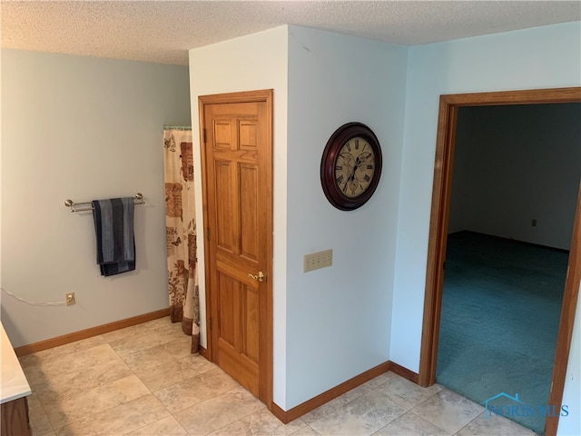 interior space featuring a textured ceiling and tile patterned floors