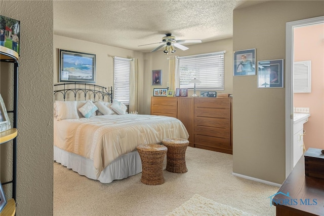 carpeted bedroom featuring a textured ceiling and ceiling fan